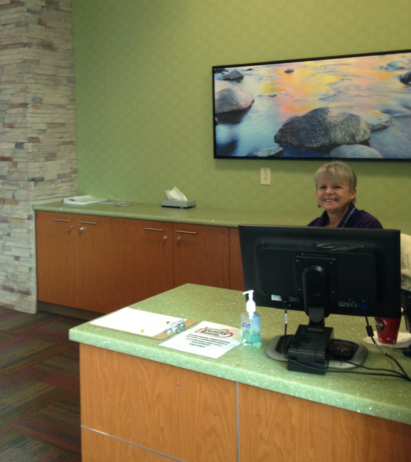 Volunteer at the reception desk in a Ronald McDonald Family Room