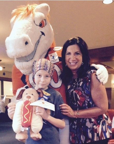 Woman with a small girl standing beside the Denver Bronco mascot