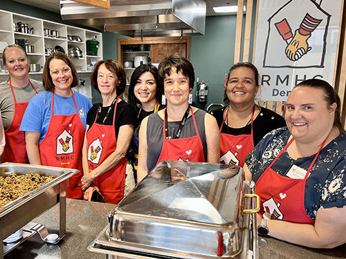 Staff cooking dinner for families