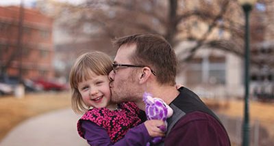 RMHC family - dad kissing daughter on her cheek