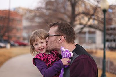 RMHC family - dad kissing daughter on her cheek